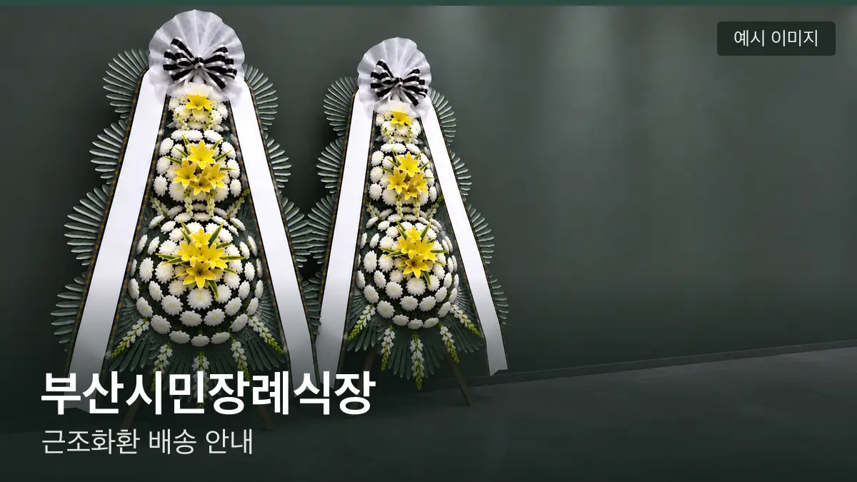 부산시민장례식장 근조화환 예시 이미지 — 흰 국화 3단 근조화환이 벽을 따라 나란히 놓인 모습