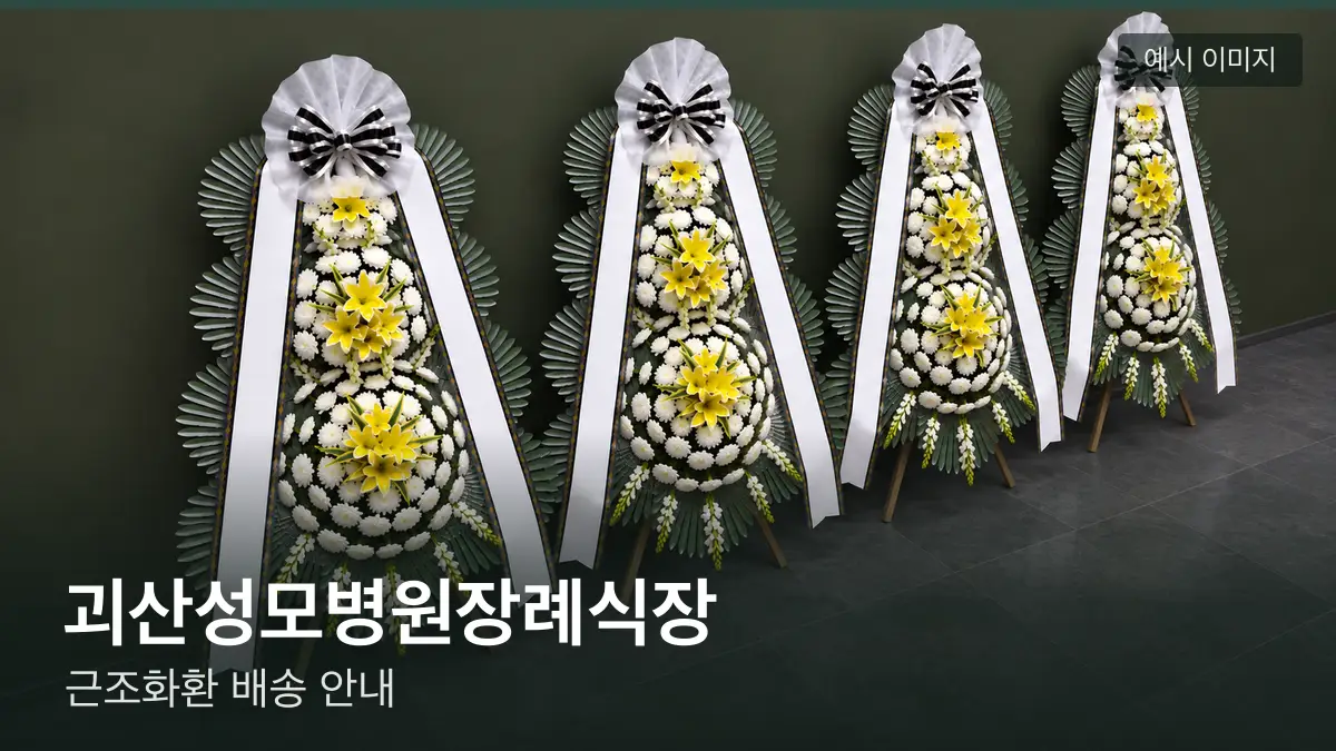 괴산성모병원장례식장 근조화환 예시 이미지 — 흰 국화 3단 근조화환이 벽을 따라 나란히 놓인 모습